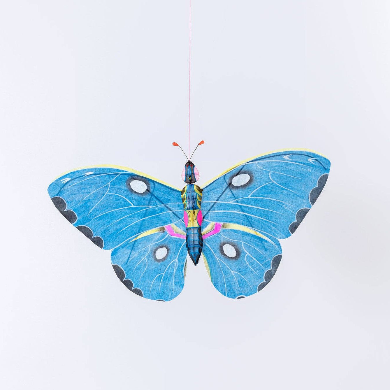 Colorful butterfly-shaped kite on a white background