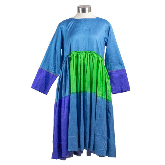 Long sleeve blue silk dress with green and purple color block pattern, gathered waist and pleated skirt