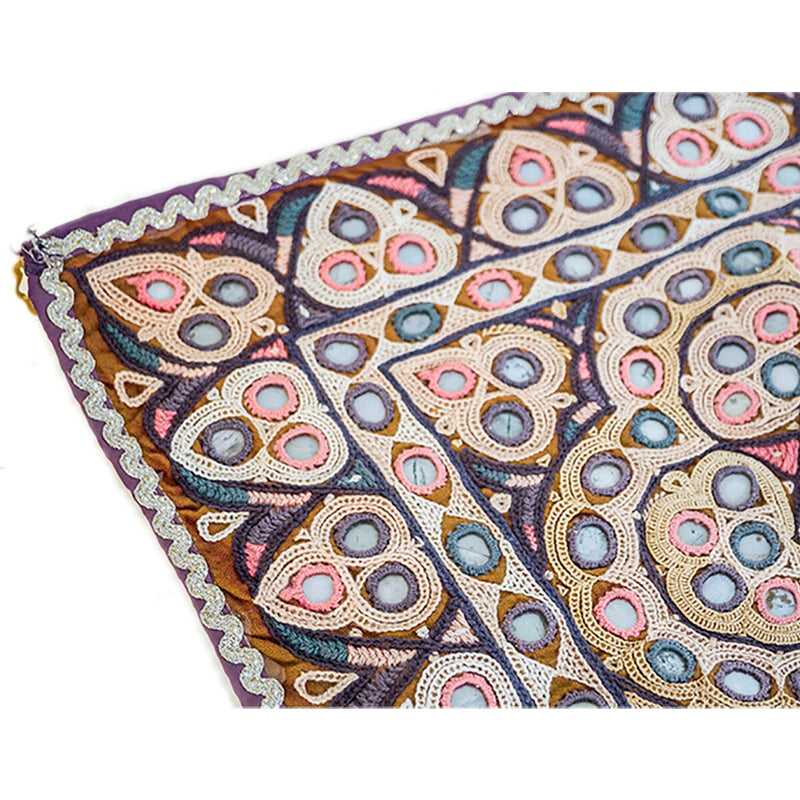 Colorful Indian door hanging with pieces of mirror, multicolored embroidery and tassels. Close up