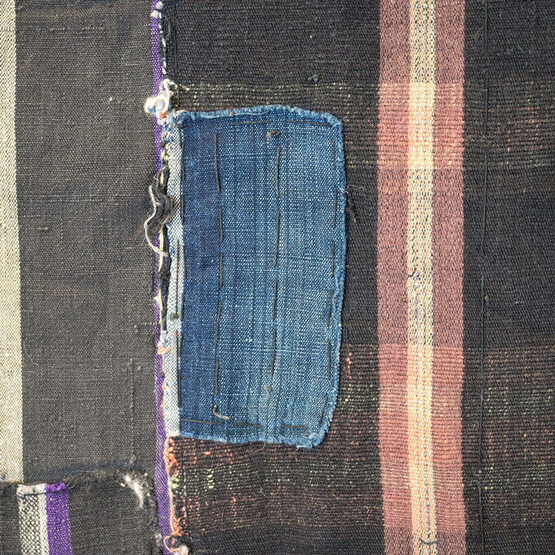 Vintage Japanese boro with vertical line pattern and indigo colored patchwork, close up