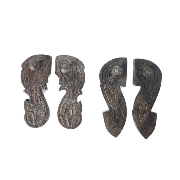 Two pairs of wood carved in a shoe shape with hand carved designs