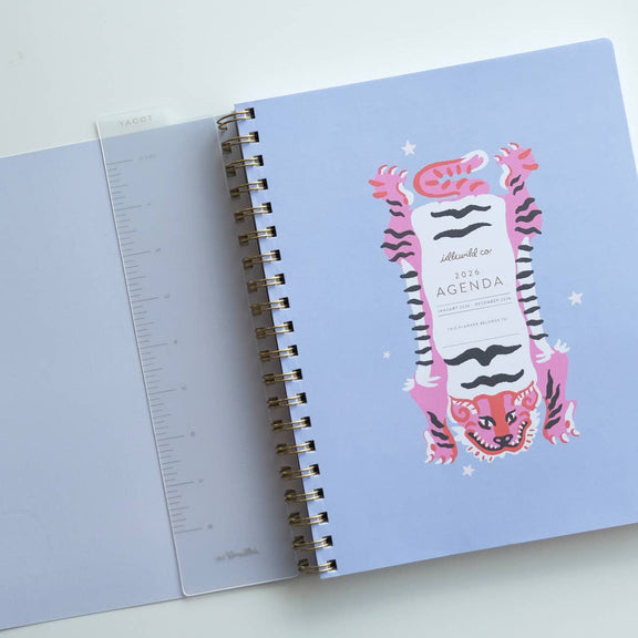 Open notebook with a tiger design on the cover on a light gray background