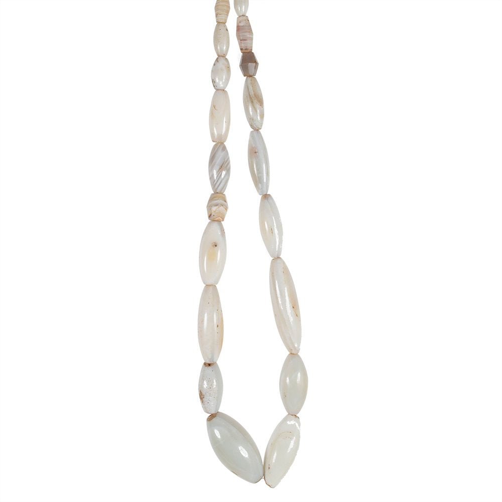 A strand of oval shaped white agate beads