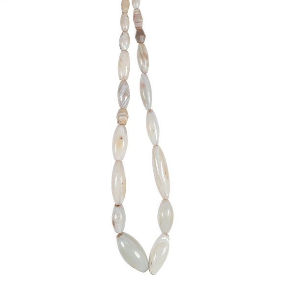 A strand of oval shaped white agate beads