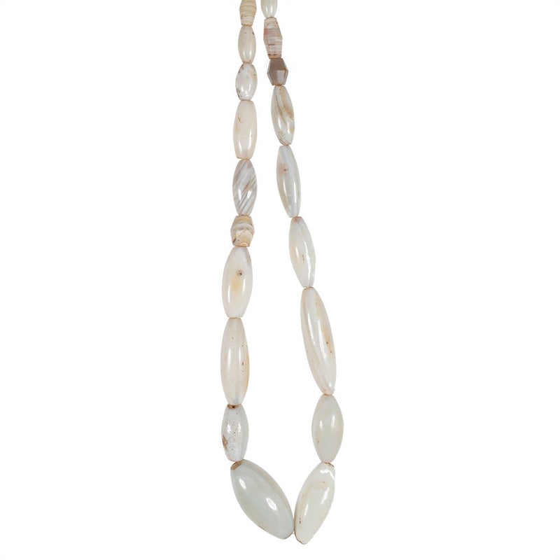 A strand of oval shaped white agate beads