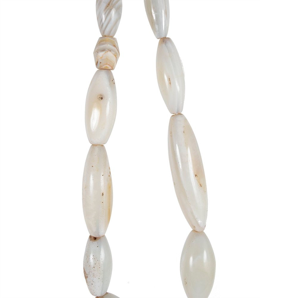 A strand of oval shaped white agate beads