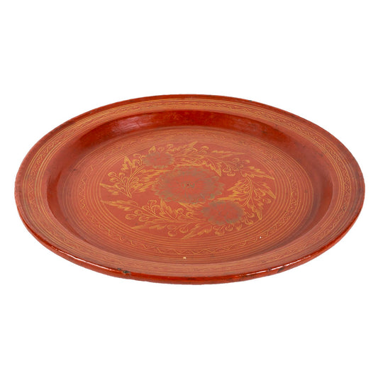 Red lacquerware dish with painted gold flowers, side view