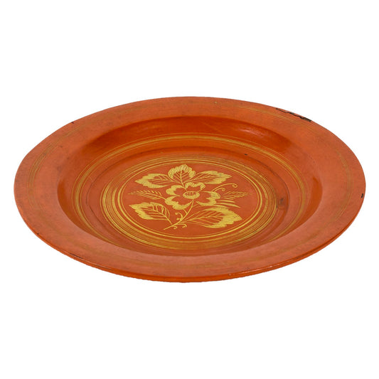 Red lacquerware dish with yellow painted flower, side view