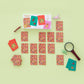 Memory game with cards and a magnifying glass on a light green background