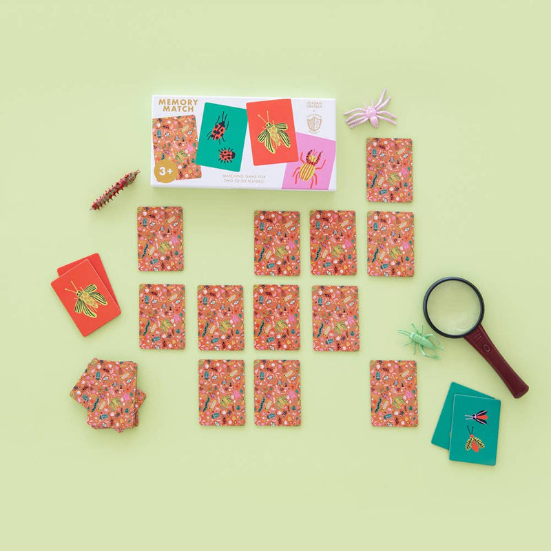 Memory game with cards and a magnifying glass on a light green background