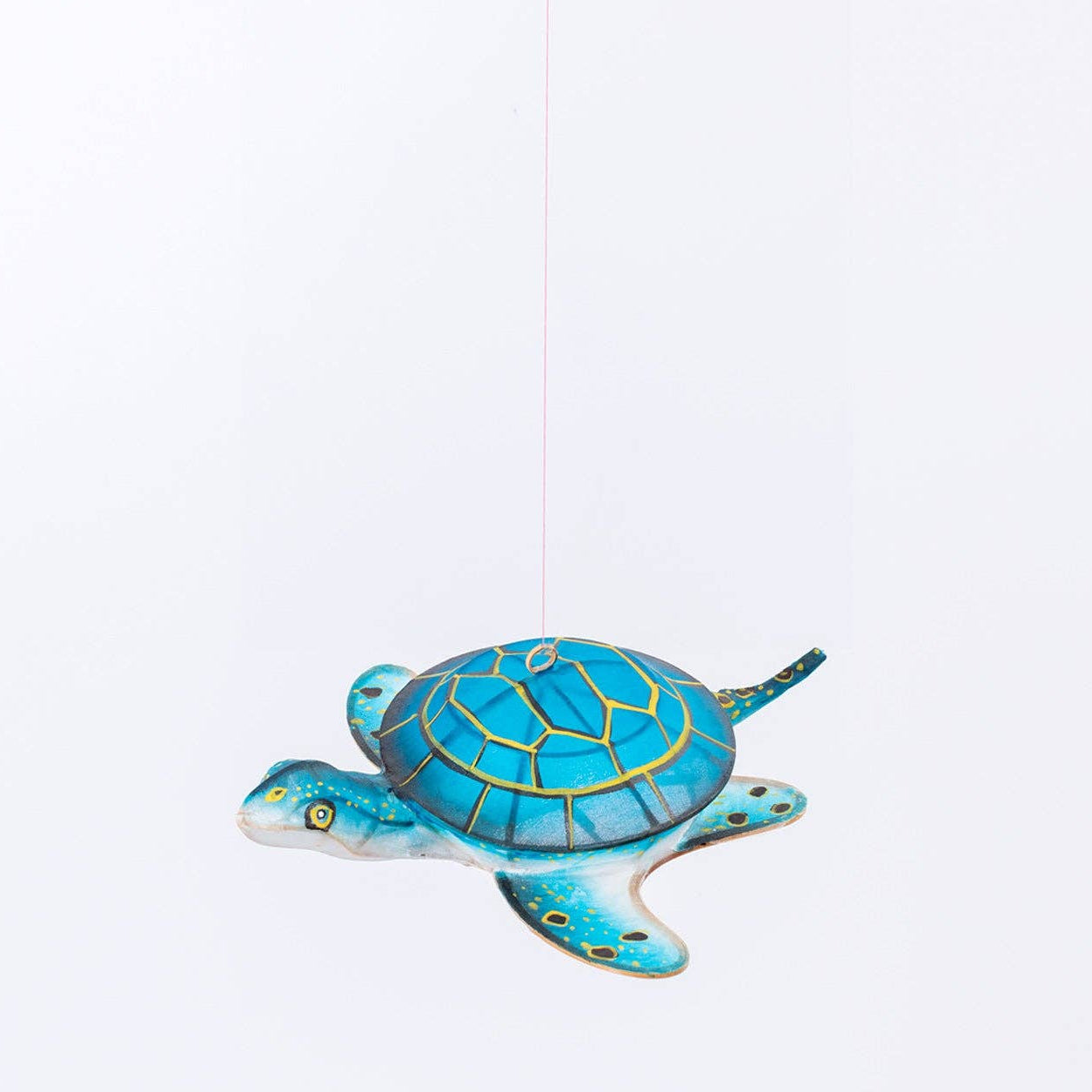 Blue turtle-shaped ornament on a white background