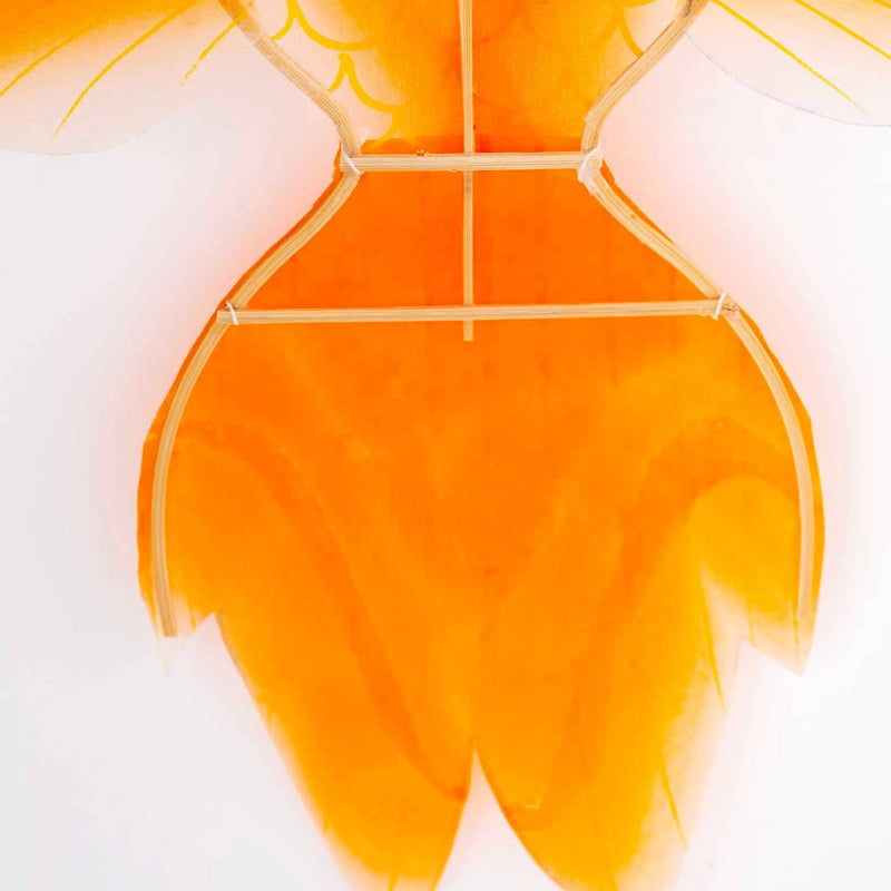 Close-up of a goldfish-shaped lantern with orange and white colors on a white background