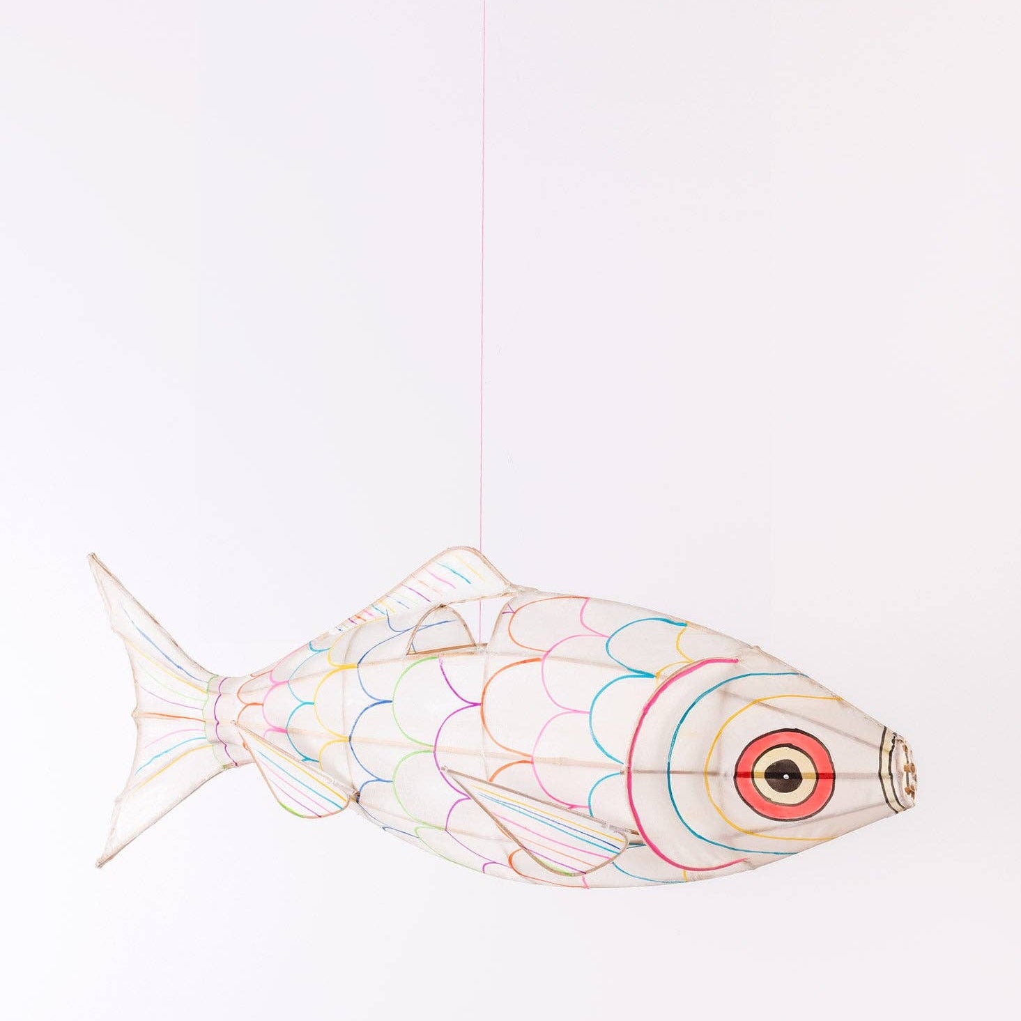 Decorative fish-shaped object with colorful patterns on a white background