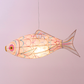 Fish-shaped lamp with colorful design on a plain background