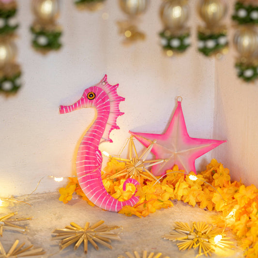 Decorative items including a pink seahorse and starfish on a surface with flowers and lights.