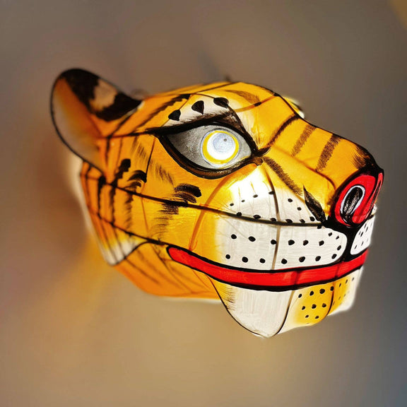 Tiger head lamp with detailed design on a plain background