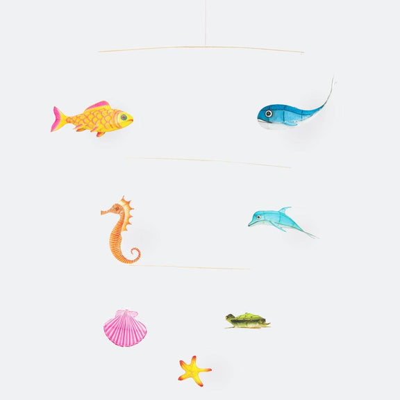 Colorful fish, seahorse, shell, turtle, and starfish on a white background