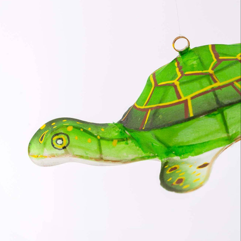 Green turtle ornament on a white background
