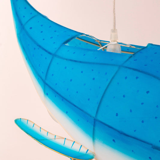 Blue kayak with a paddle on a light pink background