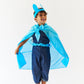 Child wearing a blue superhero costume with cape and mask on a white background