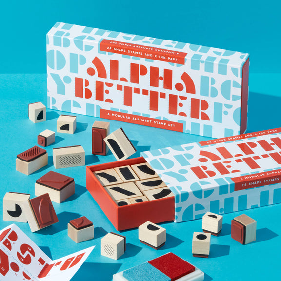 Alpha Better stamp set with packaging on a blue background