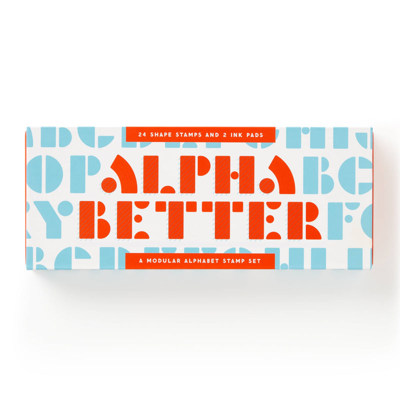 A rectangular product box for an alphabet stamp set, featuring the words 'ALPHA BETTER' in large orange letters over a white background with light blue repeating letters. Orange banners at the top and bottom read '24 SHAPE STAMPS AND 2 INK PADS' and 'A MODULAR ALPHABET STAMP SET'.