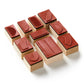 Set of wooden stamps with red rubber pads on a white background