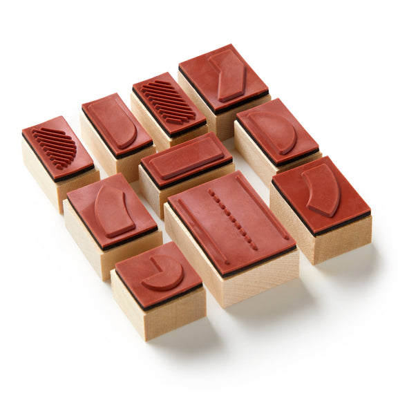 Set of wooden stamps with red rubber pads on a white background