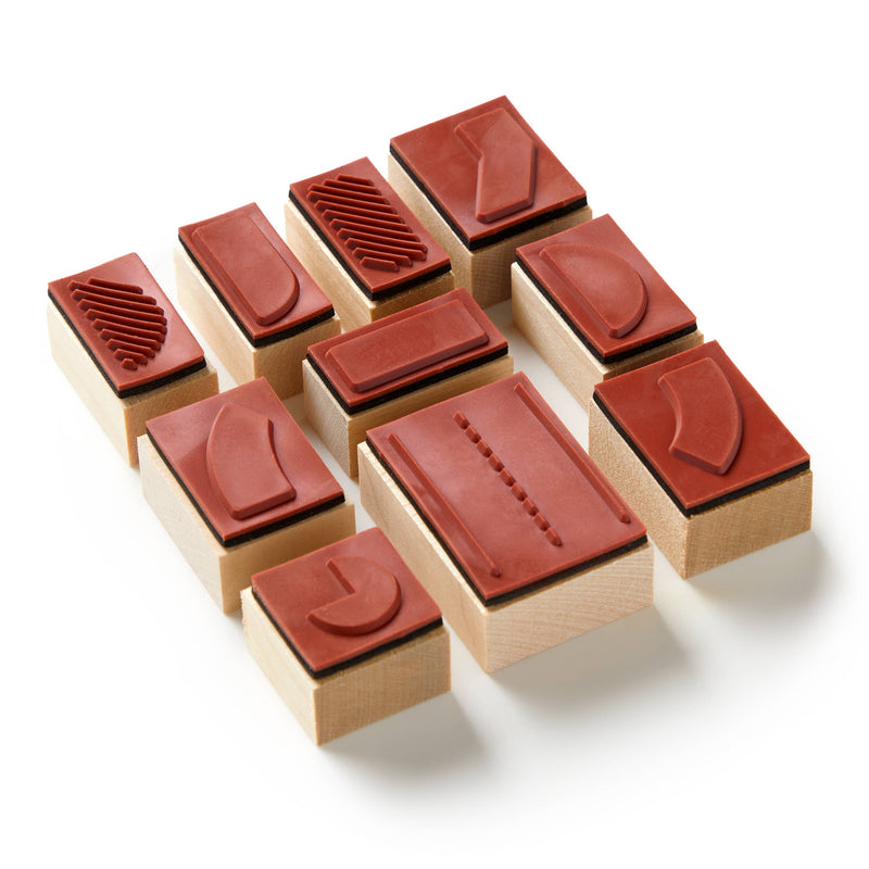 Set of wooden stamps with red rubber pads on a white background