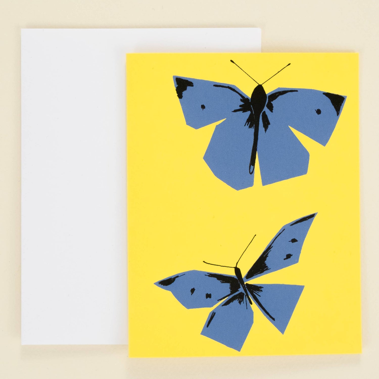 Yellow card with blue butterflies on a beige background
