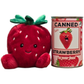 Plush strawberry toy next to a can of 'Canned Strawberry' on a white background