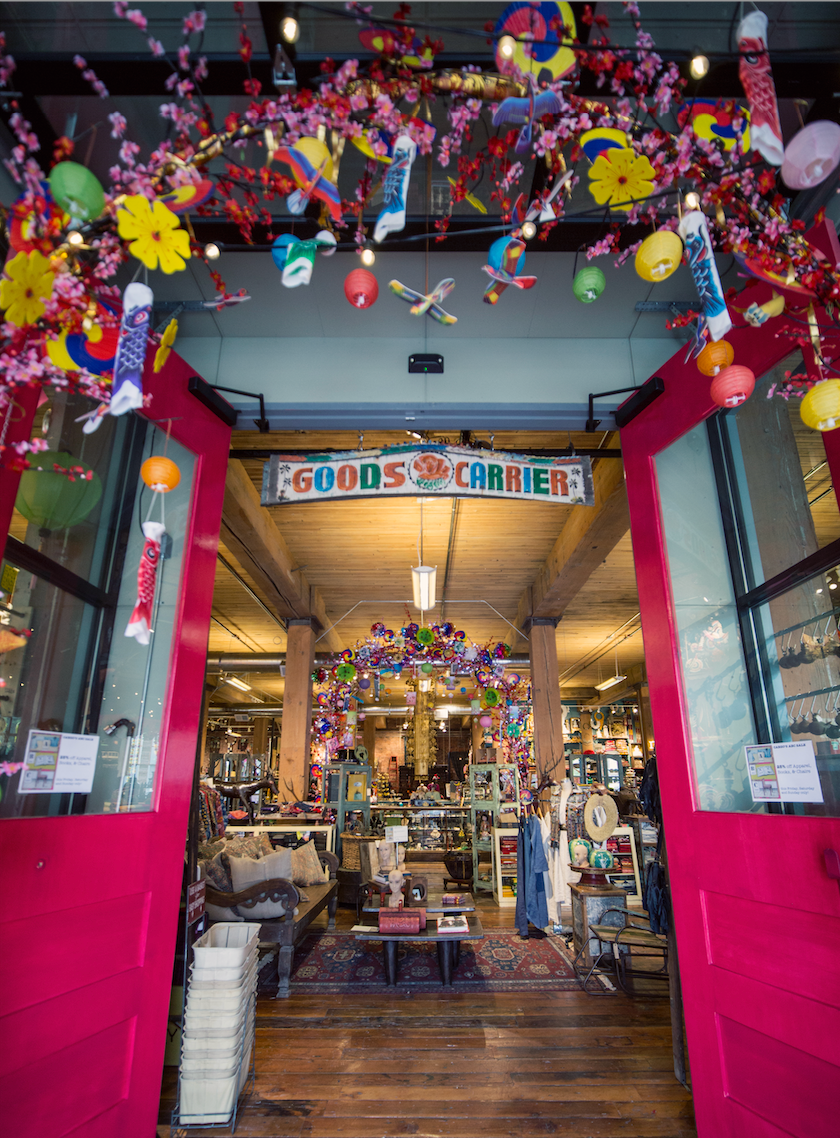 An entry to a store with red doors and a brightly colored archway