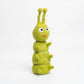 Green plush toy with a happy expression on a white background