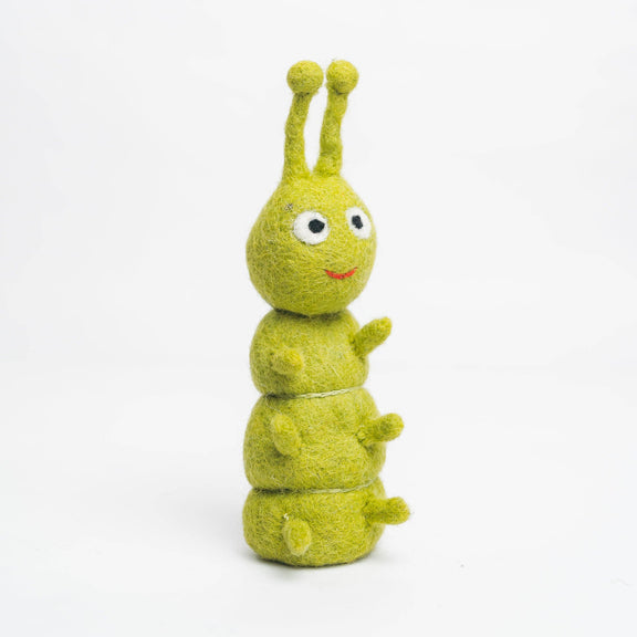 Green plush toy with a happy expression on a white background