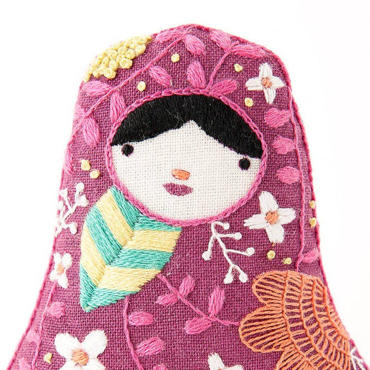 Decorative item resembling a traditional Russian matryoshka doll with floral patterns on a white background