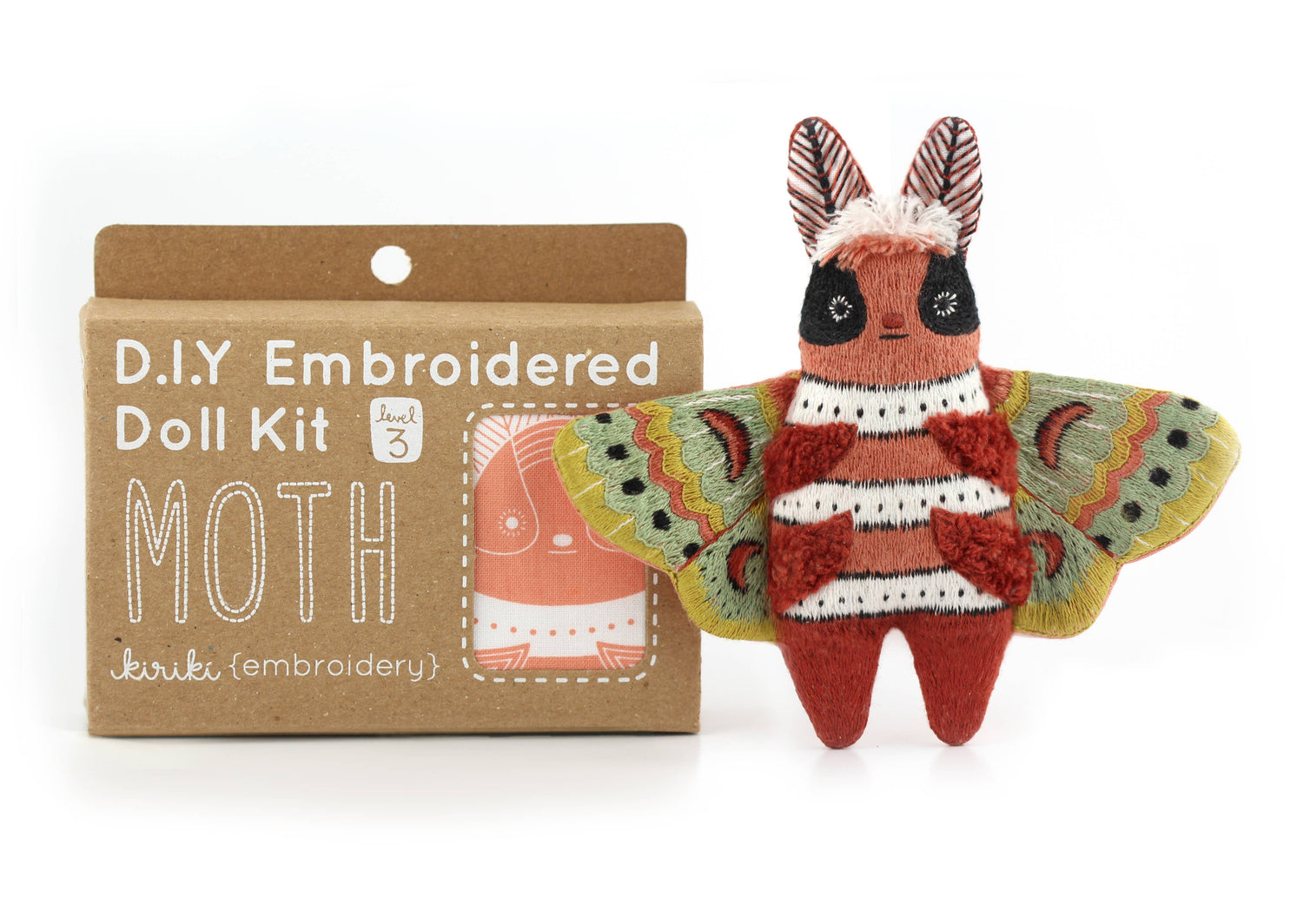 Embroidered moth doll with packaging labeled 'D.I.Y. Embroidered Doll Kit Moth' on a white background