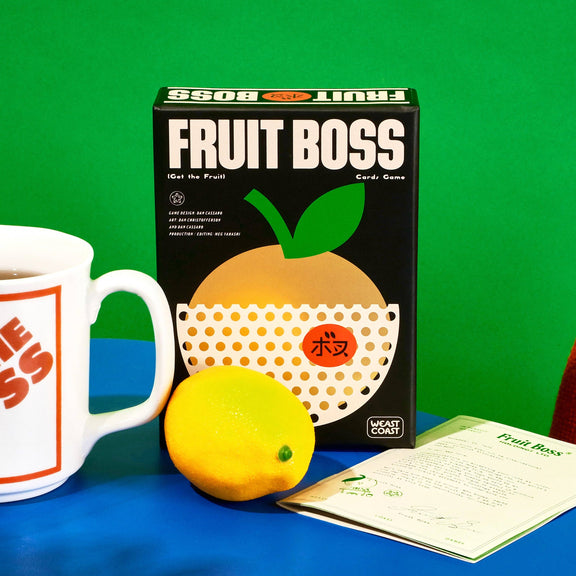 Fruit Boss game box with a mug labeled 'The Boss' and a lemon on a blue surface against a green background.