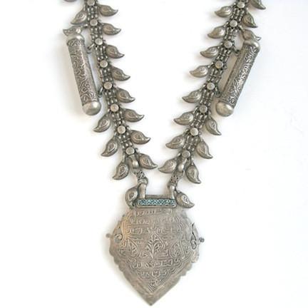 Silver necklace with leaf shaped charms and geometric pendant