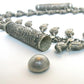 Silver necklace with leaf shaped charms and geometric pendant, close up on chain