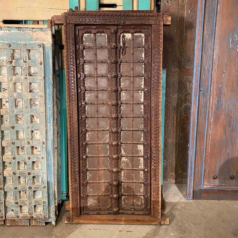 Brown decorative wood shutters with teak and iron details