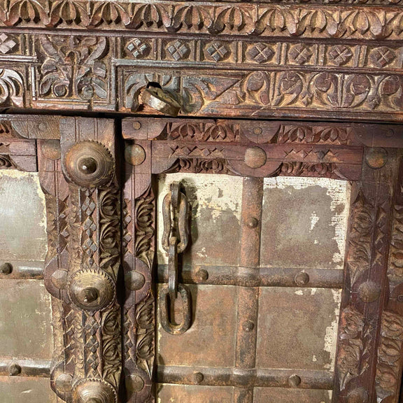Brown decorative wood shutters with teak and iron details, close up