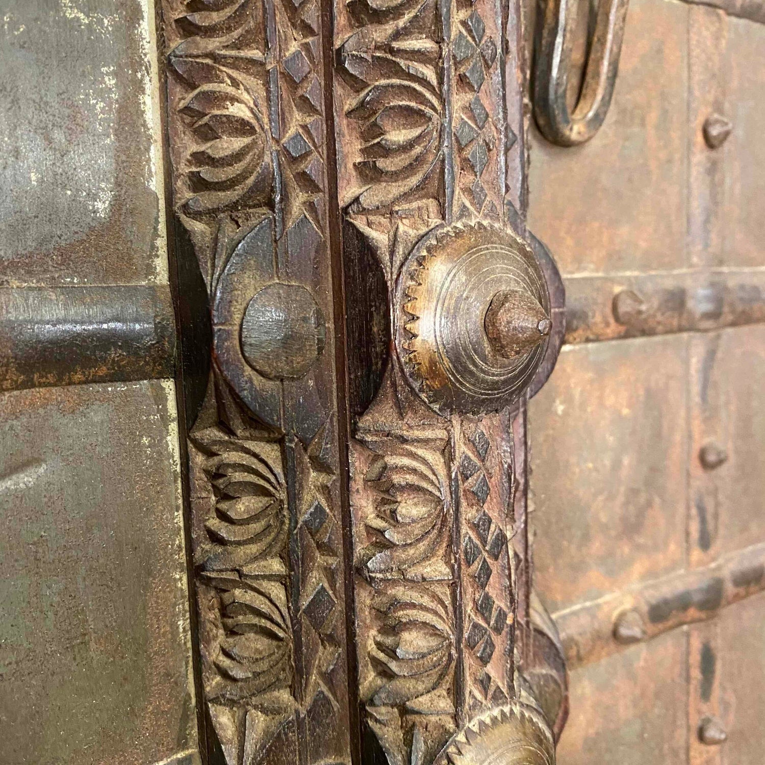 Brown decorative wood shutters with teak and iron details, close up