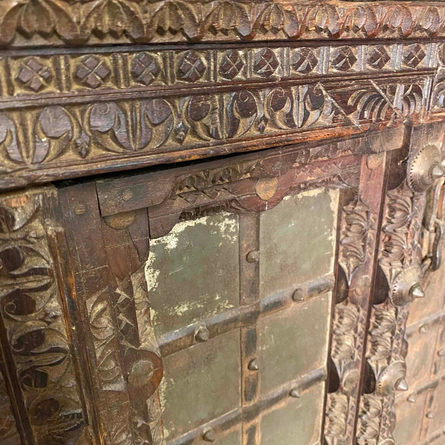 Brown decorative wood shutters with teak and iron details, close up