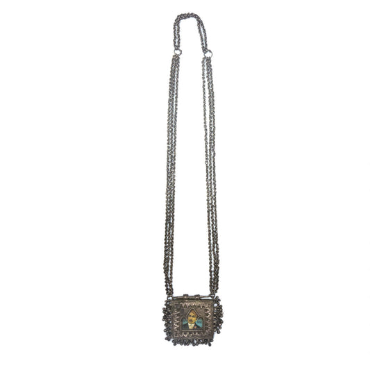 Silver necklace with a picture of a man in the center and small bell charms