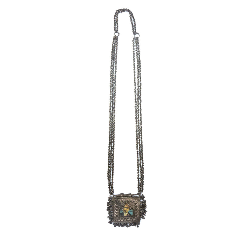 Silver necklace with a picture of a man in the center and small bell charms
