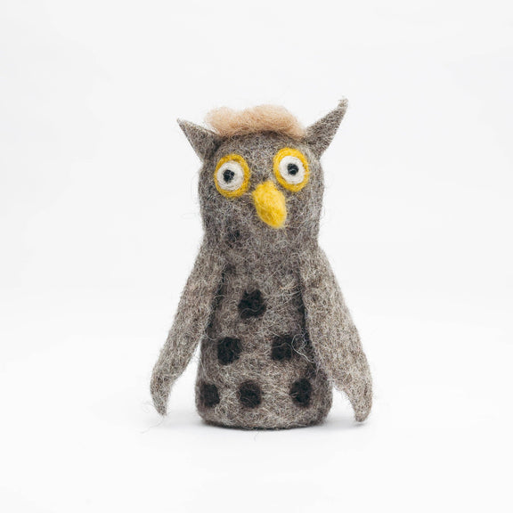 Stuffed owl toy with black spots on a white background