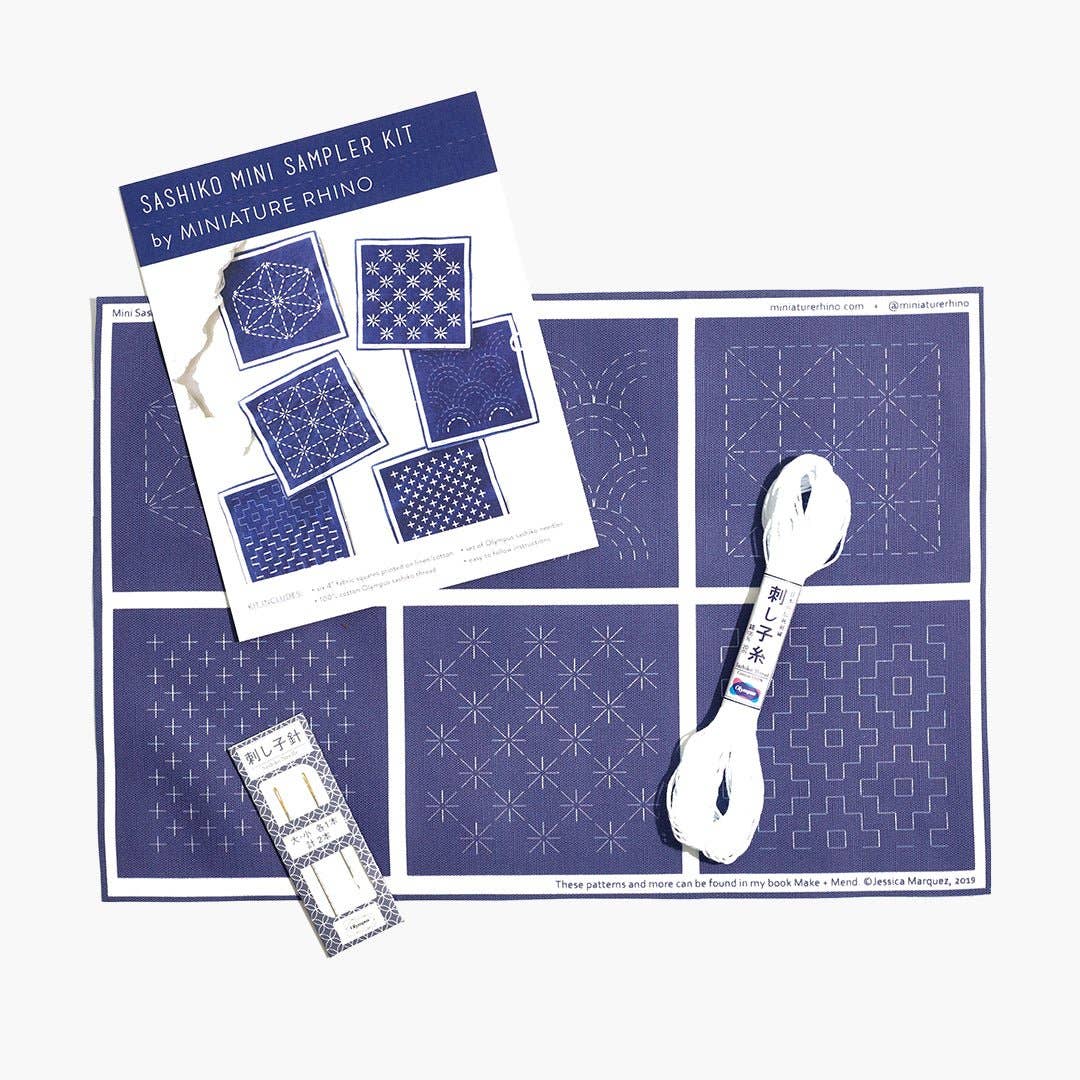 Sashiko mini sampler kit with patterns and a spoon on a white background