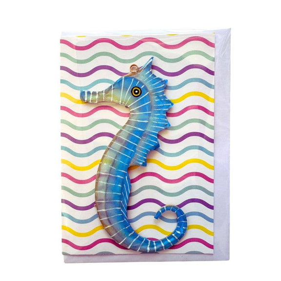 Greeting card with a blue seahorse design on a colorful wavy background
