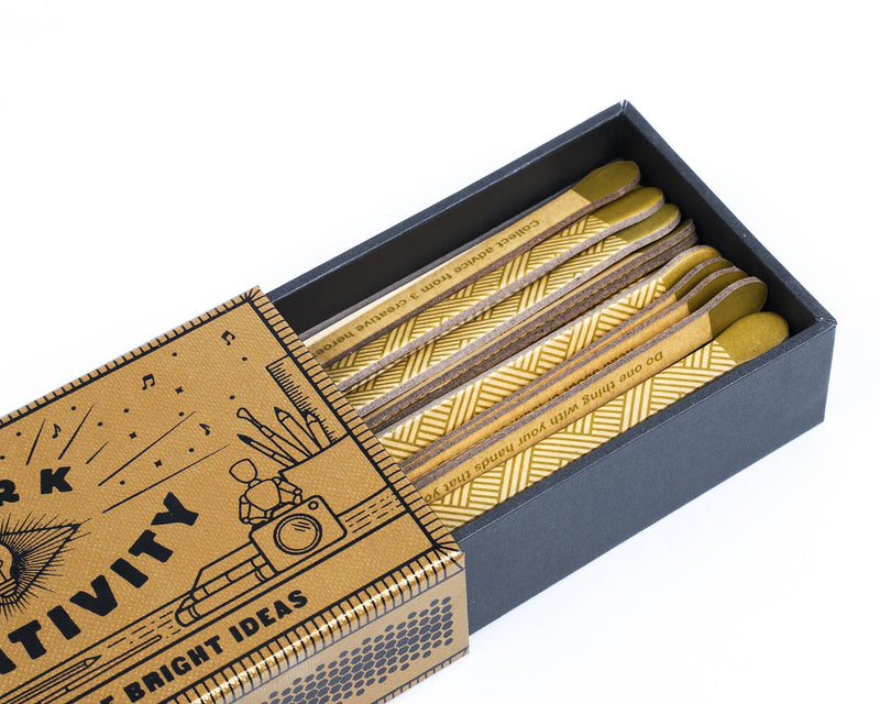 Box of pencils with a decorative cover on a white background