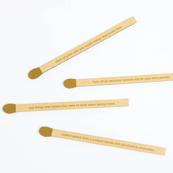 Four wooden sticks with engraved text on a white background